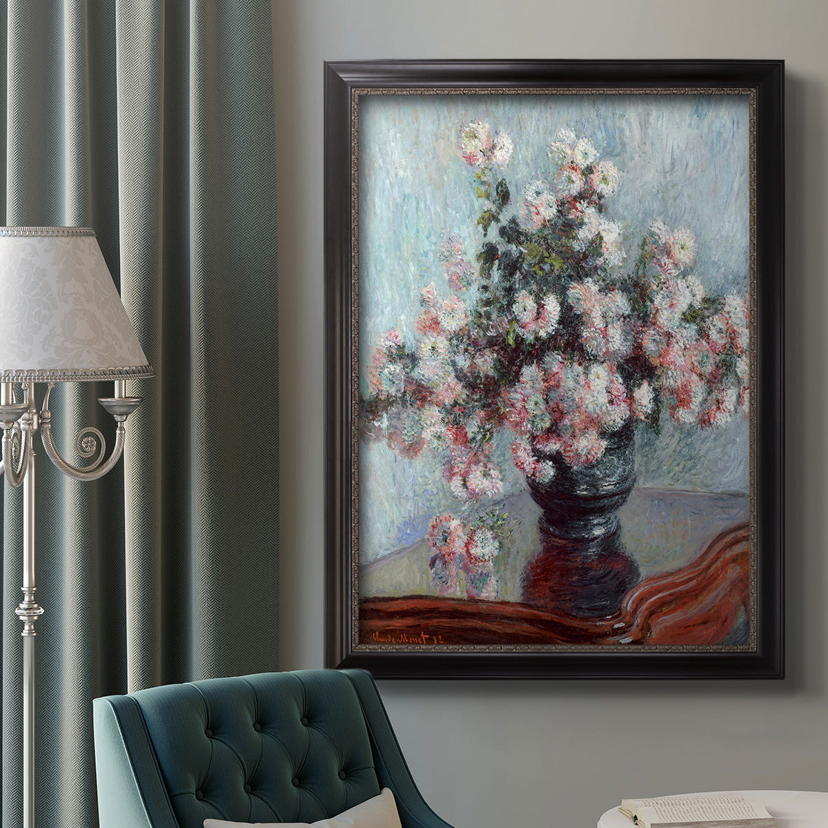Impressionist chrysanthemum floral painting by Claude Monet in an ornate black frame with gilded inner detail displayed in a neutral interior setting.