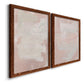 Angled view of a set of two maple barnwood framed canvas prints featuring two minimalist color-field abstracts featuring soft blush and white painterly fields.