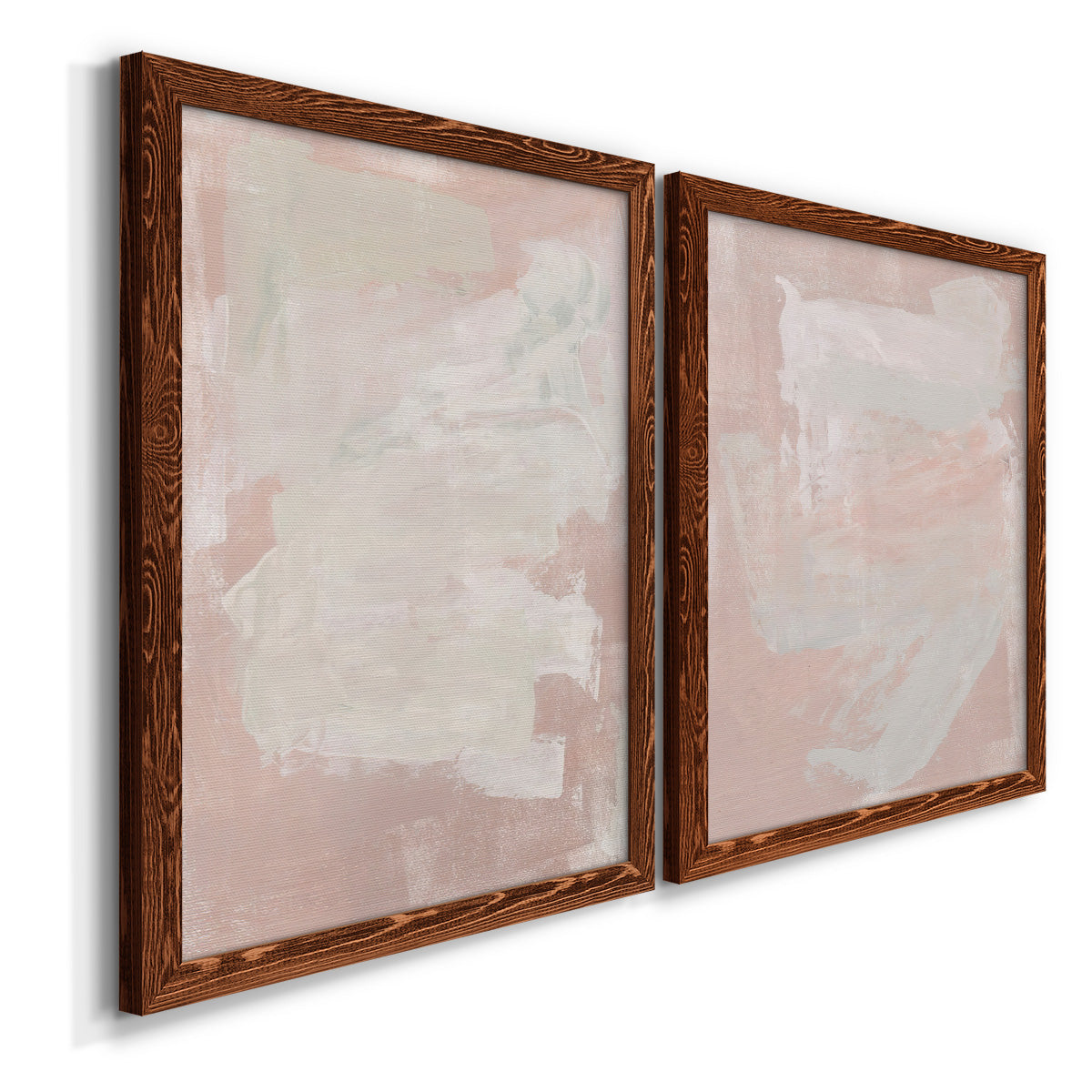 Angled view of a set of two maple barnwood framed canvas prints featuring two minimalist color-field abstracts featuring soft blush and white painterly fields.