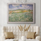 Impressionist countryside landscape near Auvers by Vincent van Gogh in an ornate weathered white frame displayed in a neutral-toned interior setting.