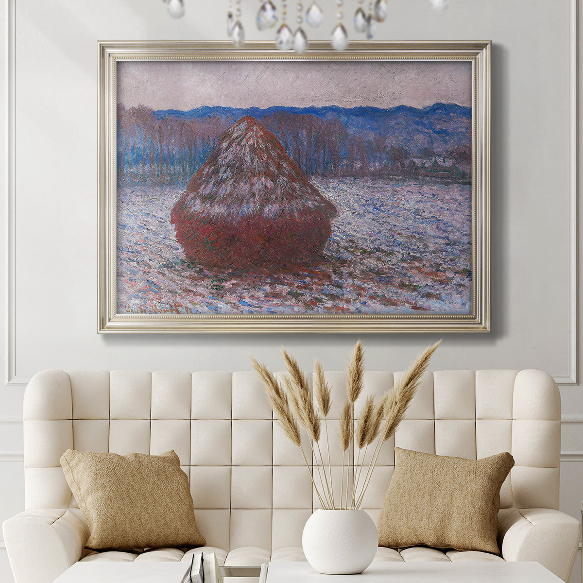 Impressionist single haystack landscape by Claude Monet in an ornate champagne frame displayed in a neutral-toned interior setting.