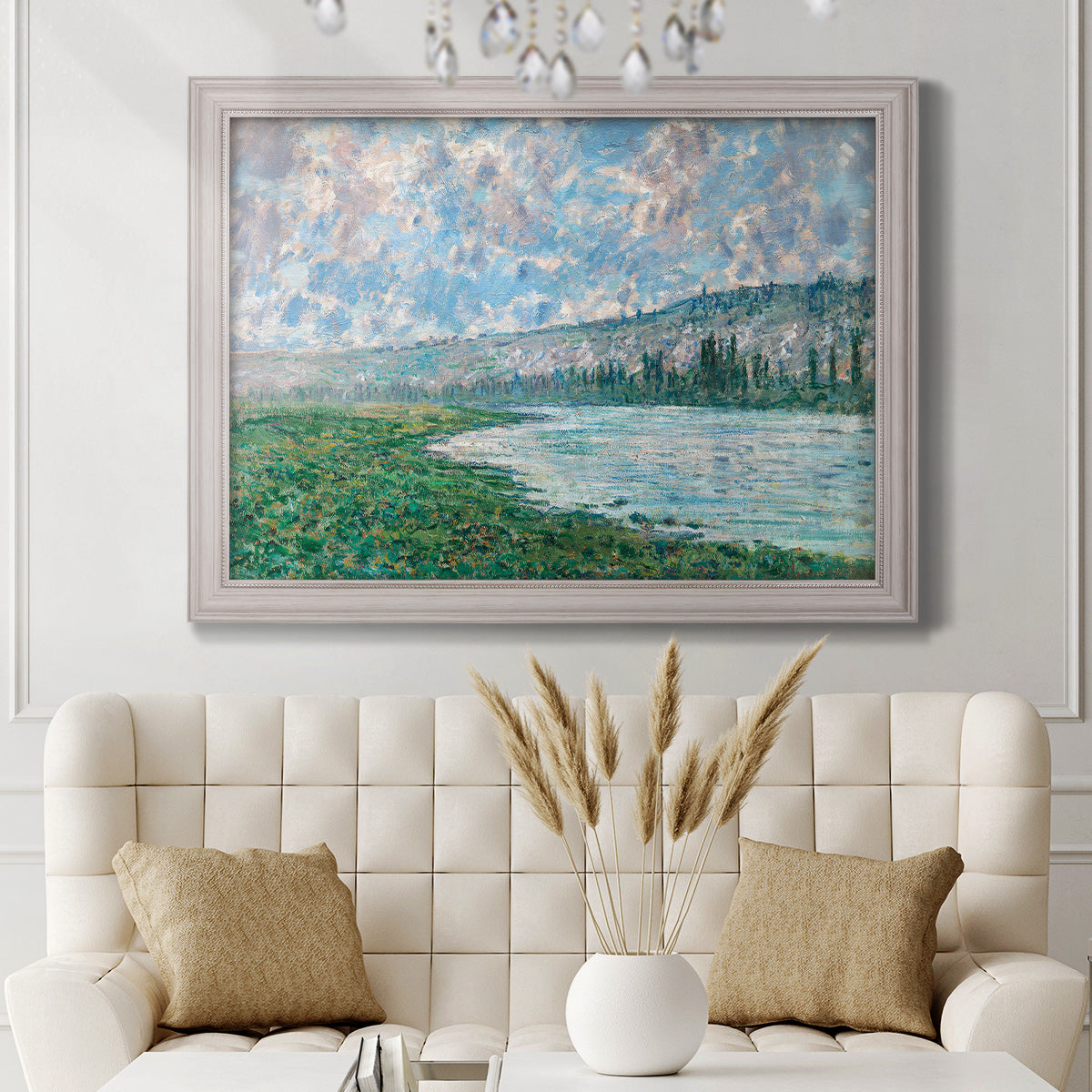 Impressionist river landscape at Vétheuil by Claude Monet in an ornate weathered white frame displayed in a neutral-toned interior setting.