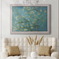 Impressionist flowering almond branch painting by Vincent van Gogh in an ornate weathered white frame displayed in a neutral-toned interior setting.