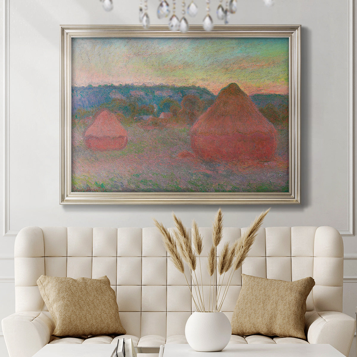 Impressionist haystack series landscape by Claude Monet in an ornate champagne frame displayed in a neutral-toned interior setting.
