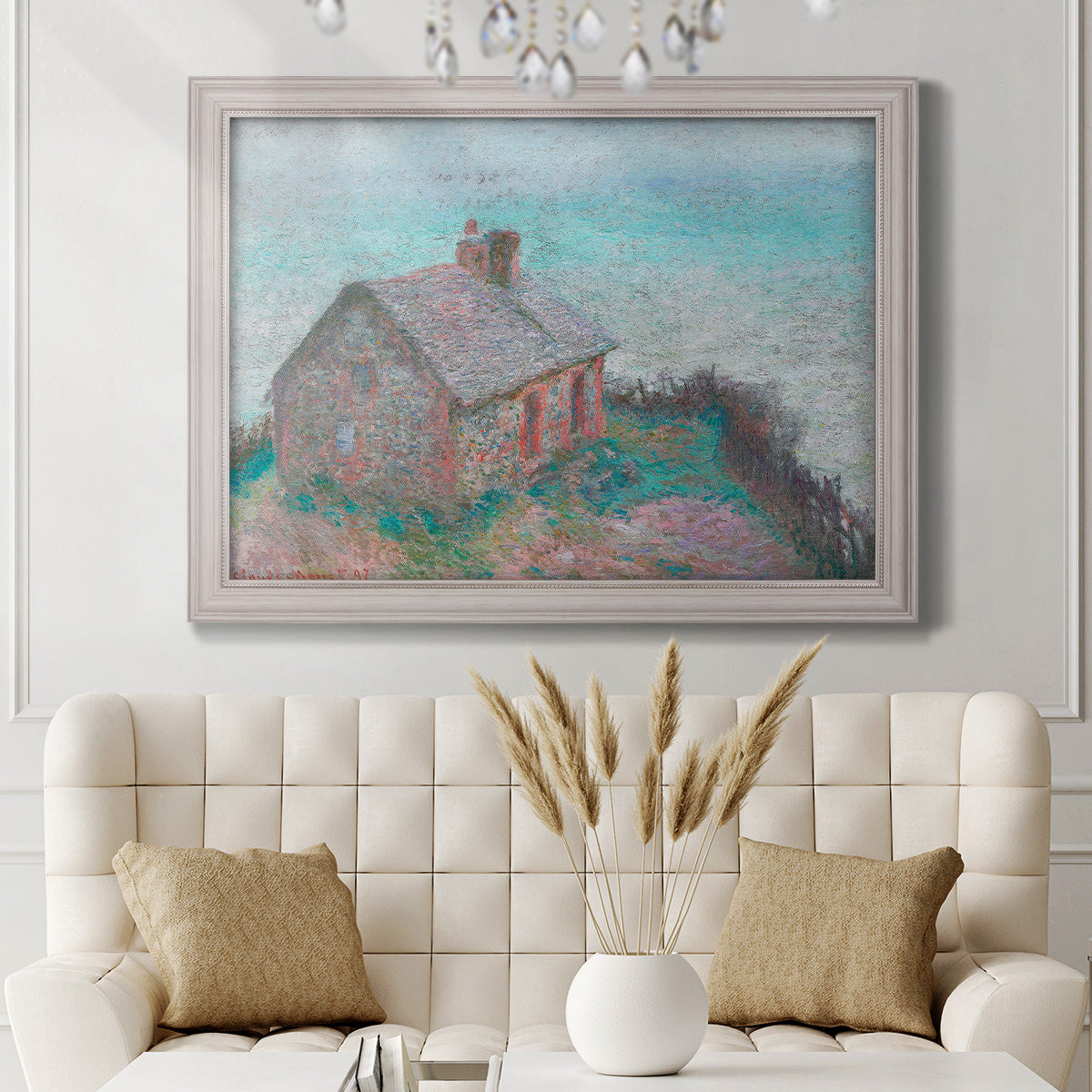 Impressionist coastal building landscape by Claude Monet in an ornate weathered white frame displayed in a neutral-toned interior setting.