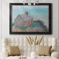 Impressionist coastal building landscape by Claude Monet in an ornate black frame with gilded inner detail displayed in a neutral-toned interior setting.