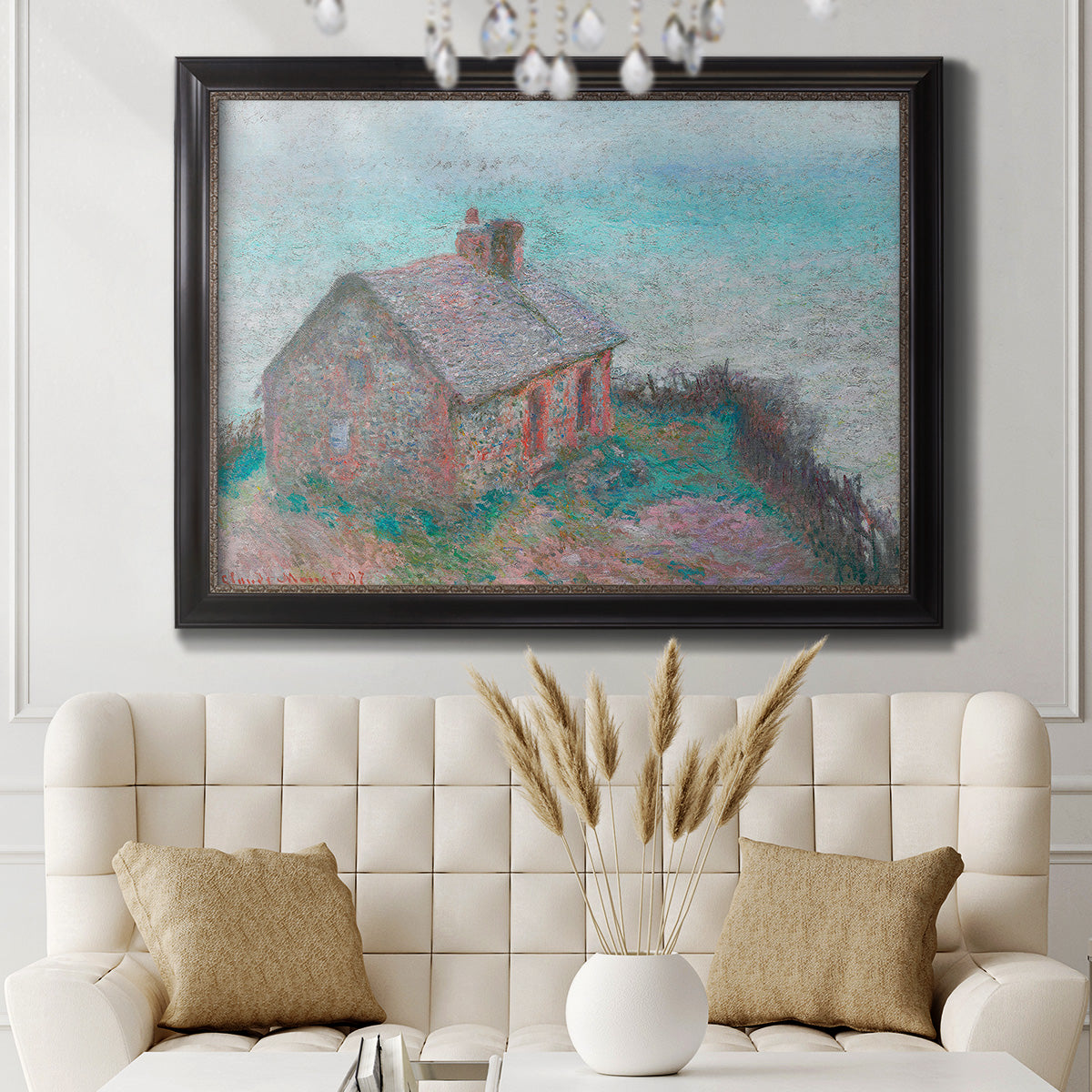 Impressionist coastal building landscape by Claude Monet in an ornate black frame with gilded inner detail displayed in a neutral-toned interior setting.