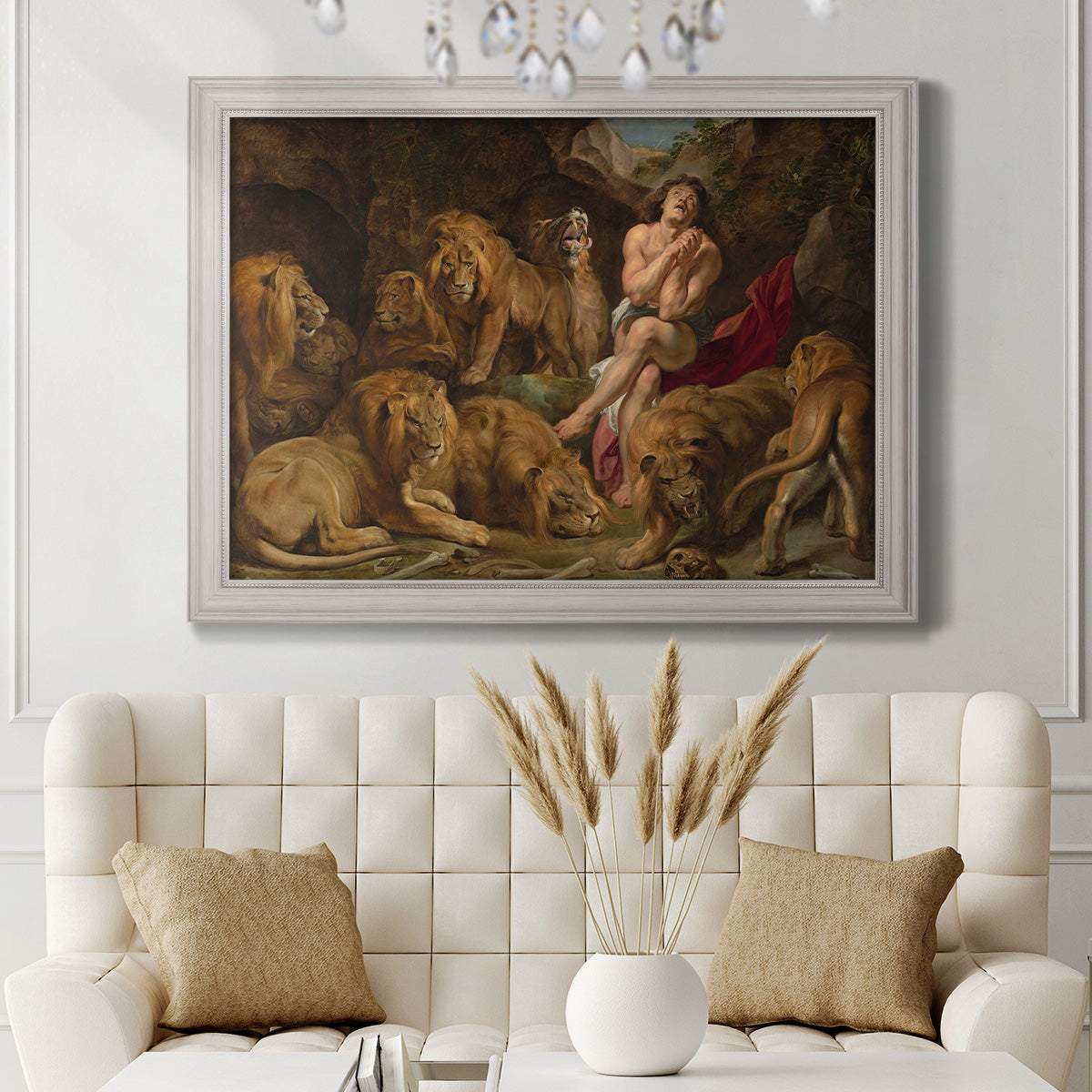 Dramatic biblical painting of Daniel with lions by Peter Paul Rubens in an ornate weathered white frame displayed in a neutral-toned interior setting.