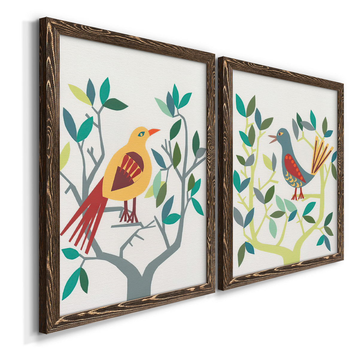 Angled view of a set of two walnut barnwood framed canvas prints featuring two modern folk-art bird illustrations featuring stylized colorful birds perched among leafy branches.