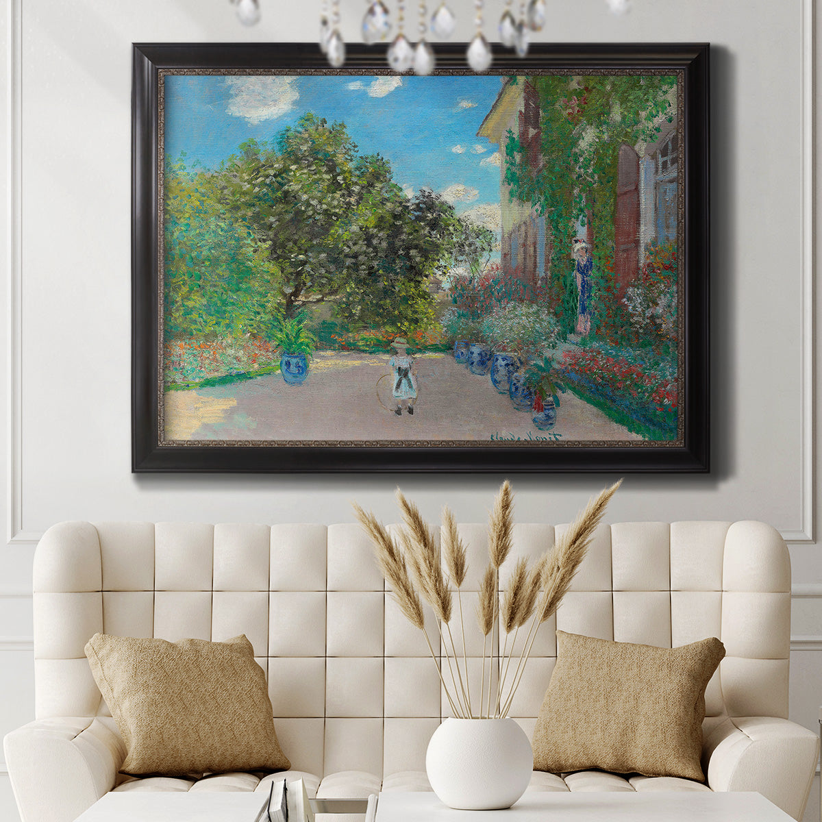 Impressionist residential landscape at Argenteuil by Claude Monet in an ornate black frame with gilded inner detail displayed in a neutral-toned interior setting.