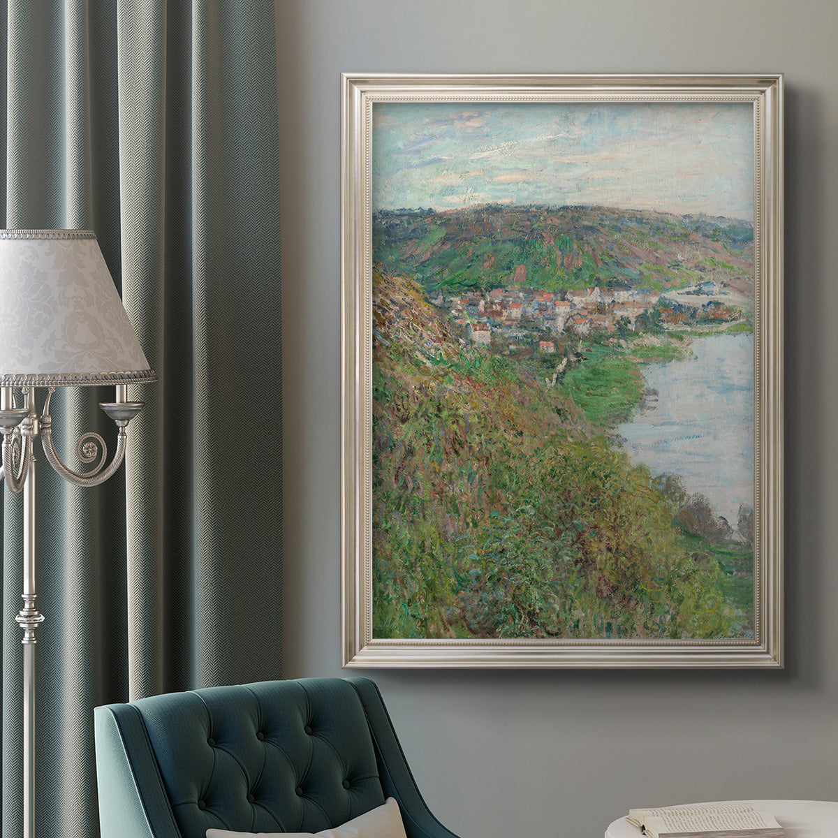 Impressionist landscape view of Vétheuil by Claude Monet in an ornate champagne frame displayed in a neutral interior setting.