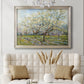 Impressionist white-blossomed orchard landscape by Vincent van Gogh in an ornate champagne frame displayed in a neutral-toned interior setting.