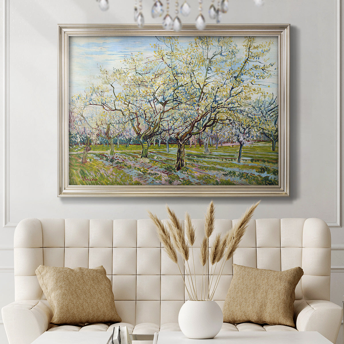 Impressionist white-blossomed orchard landscape by Vincent van Gogh in an ornate champagne frame displayed in a neutral-toned interior setting.