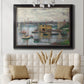 Impressionist river bridge scene on an overcast day by Claude Monet in an ornate black frame with gilded inner detail displayed in a neutral-toned interior setting.