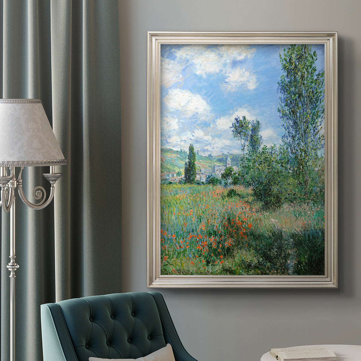 Impressionist pastoral landscape with poppy fields by Claude Monet in an ornate champagne frame displayed in a neutral interior setting.