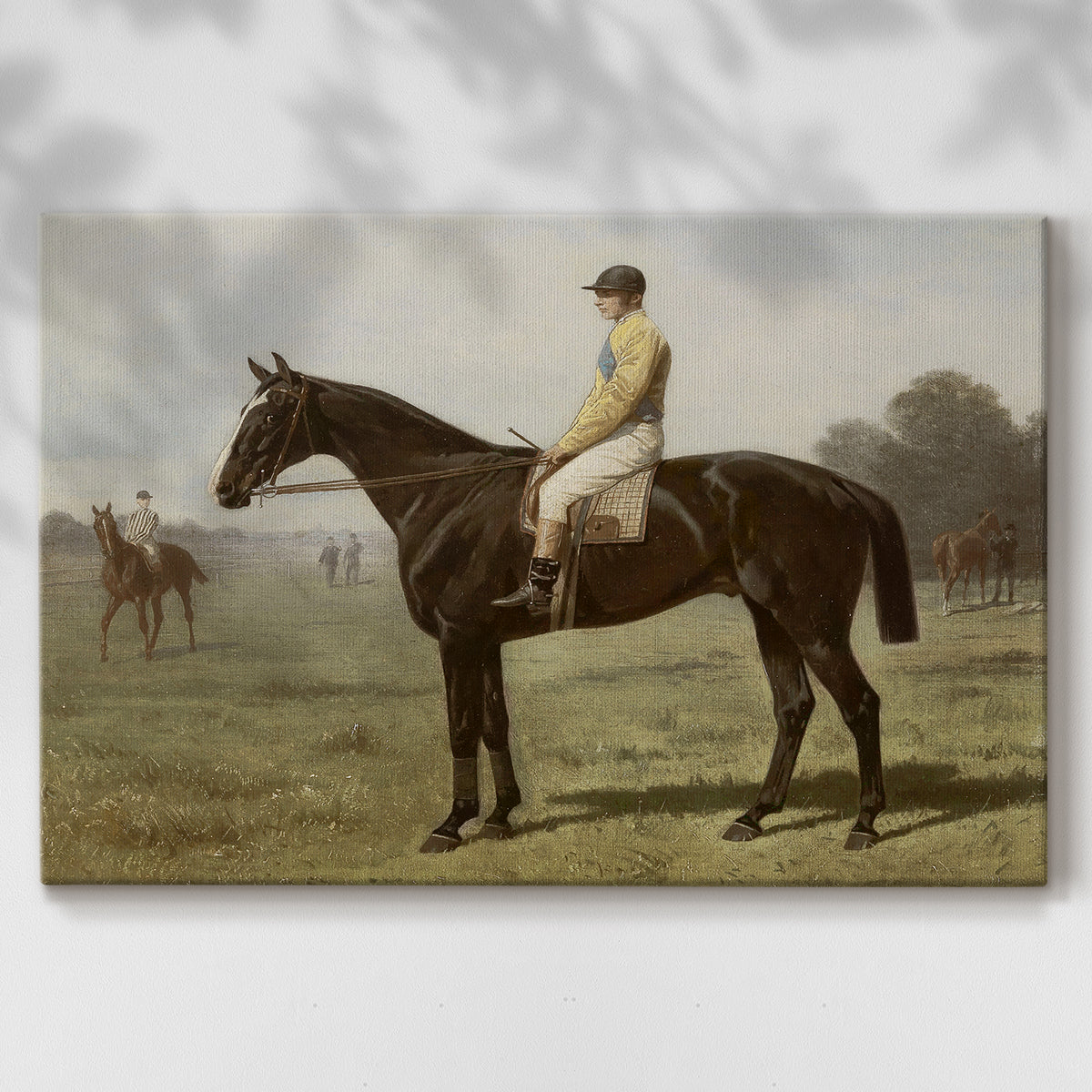 Jockey dressed in yellow sits on a black horse in a serene field during a calm afternoon