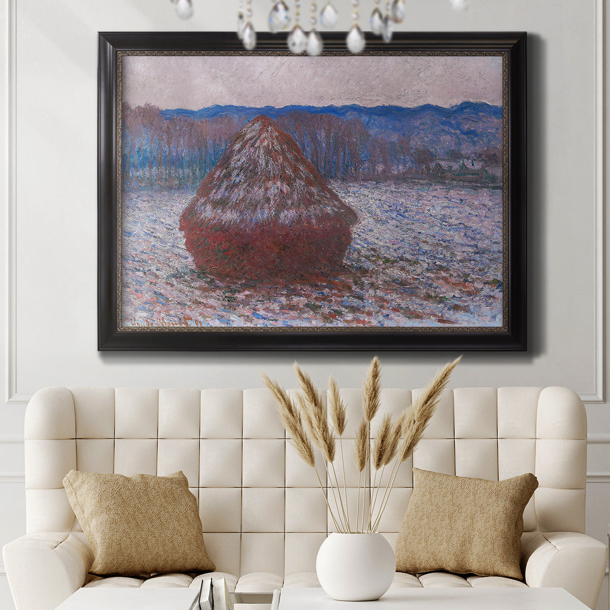 Impressionist single haystack landscape by Claude Monet in an ornate black frame with gilded inner detail displayed in a neutral-toned interior setting.