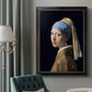 Iconic portrait of a girl wearing a pearl earring by Johannes Vermeer in an ornate black frame with gilded inner detail displayed in a neutral interior setting.