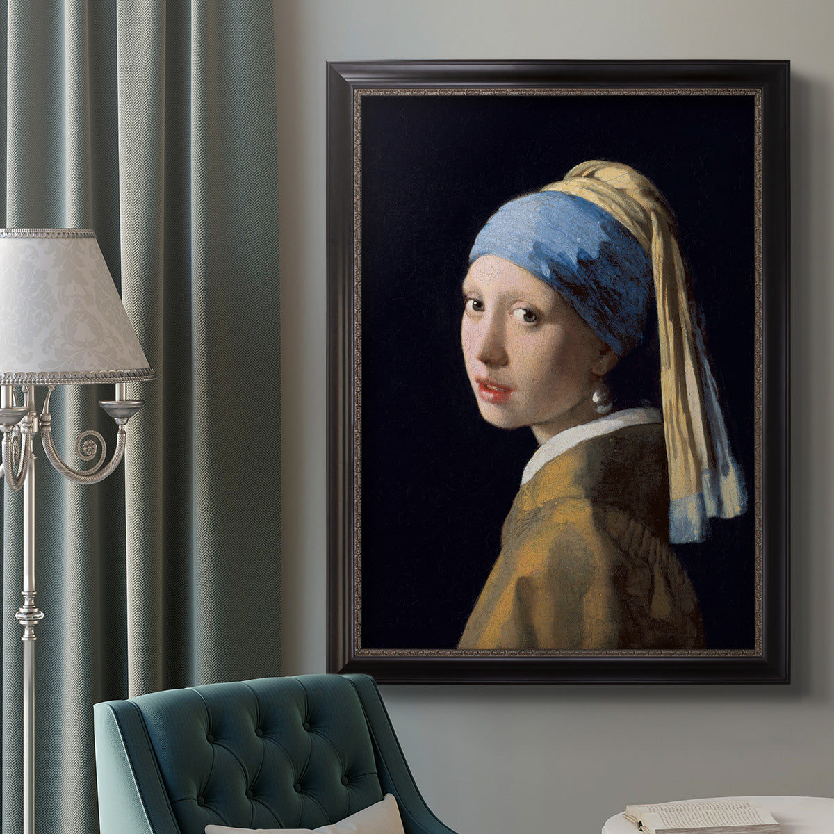 Iconic portrait of a girl wearing a pearl earring by Johannes Vermeer in an ornate black frame with gilded inner detail displayed in a neutral interior setting.
