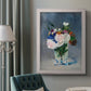Impressionist floral still life painting by Claude Monet in an ornate weathered white frame displayed in a neutral interior setting.