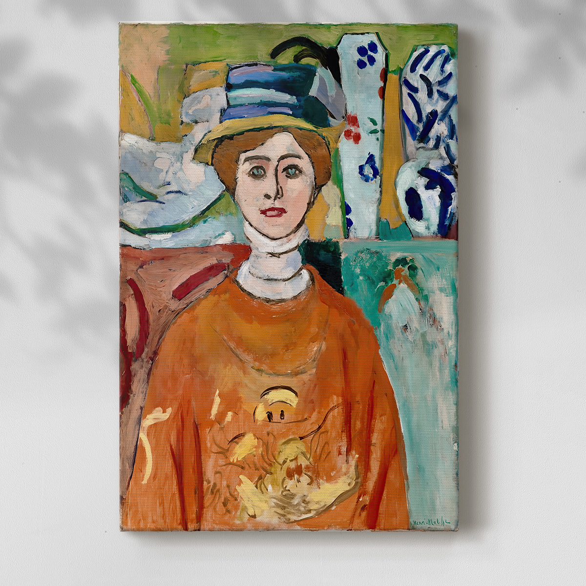 Canvas art print of a stylized face with vivid tones and simplified features with a soft shadow on a white background.
