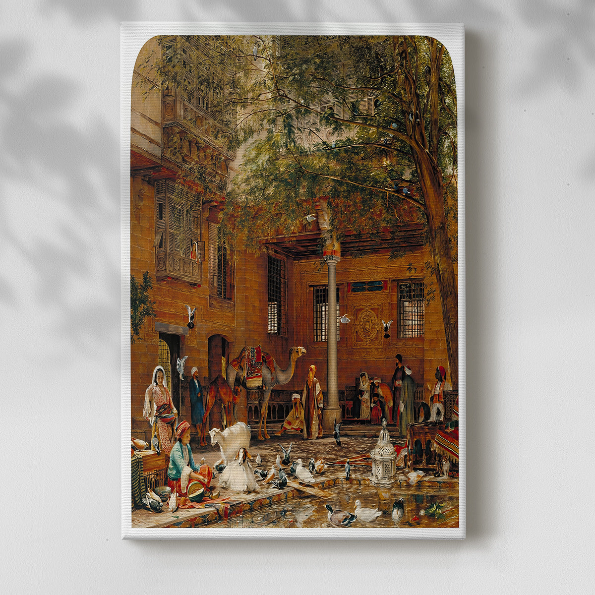 Canvas art print of a sunlit interior courtyard with arches and decorative elements with a soft shadow on a white background.