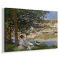Canvas art print featuring a peaceful riverside scene with figures resting in grassy area by water, displayed at an angle