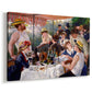 Canvas art print featuring a lively gathering of men and women eating and socializing at outdoor table, displayed at an angle