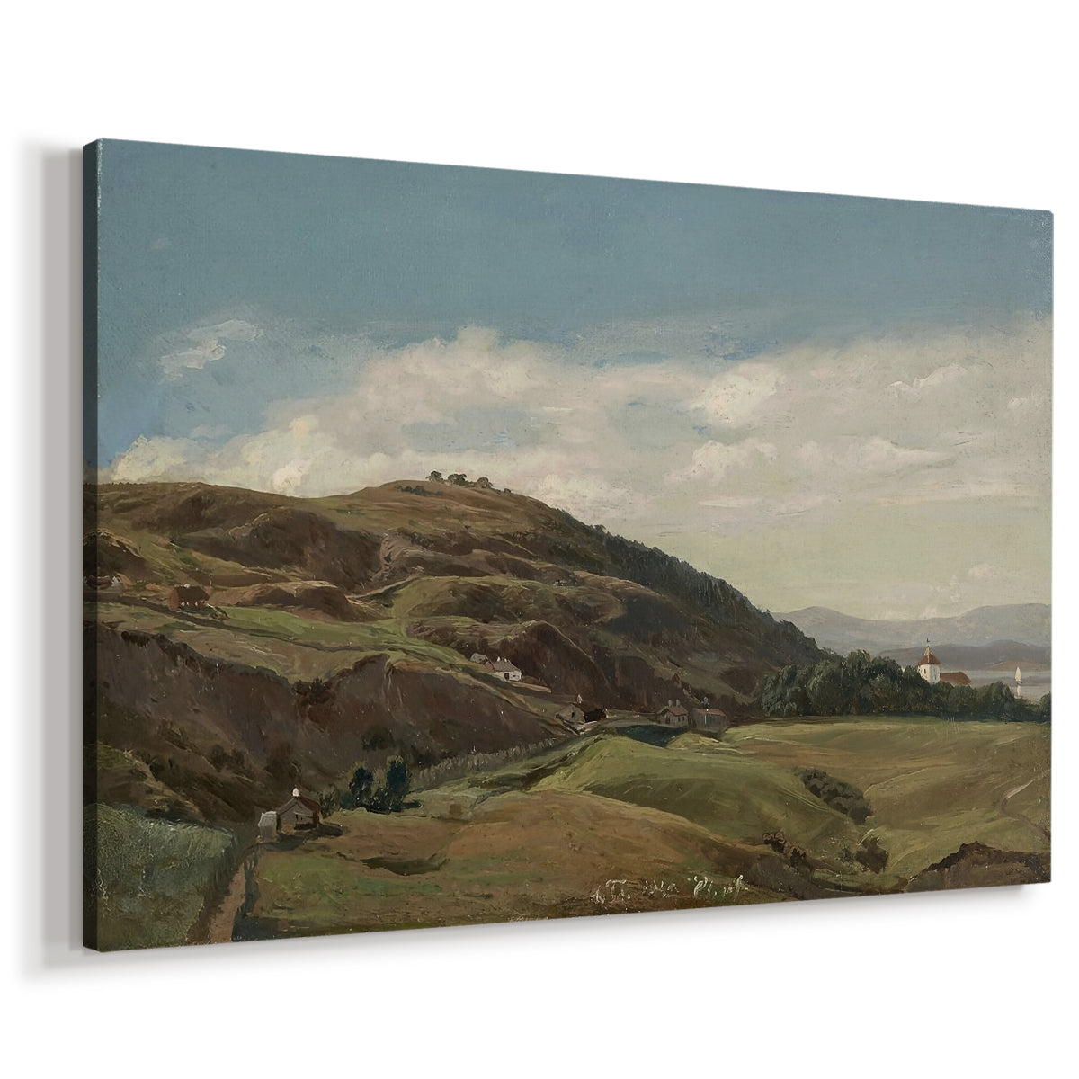 Canvas art print featuring a Norwegian countryside with distant church overlooking fjord and fields, displayed at an angle
