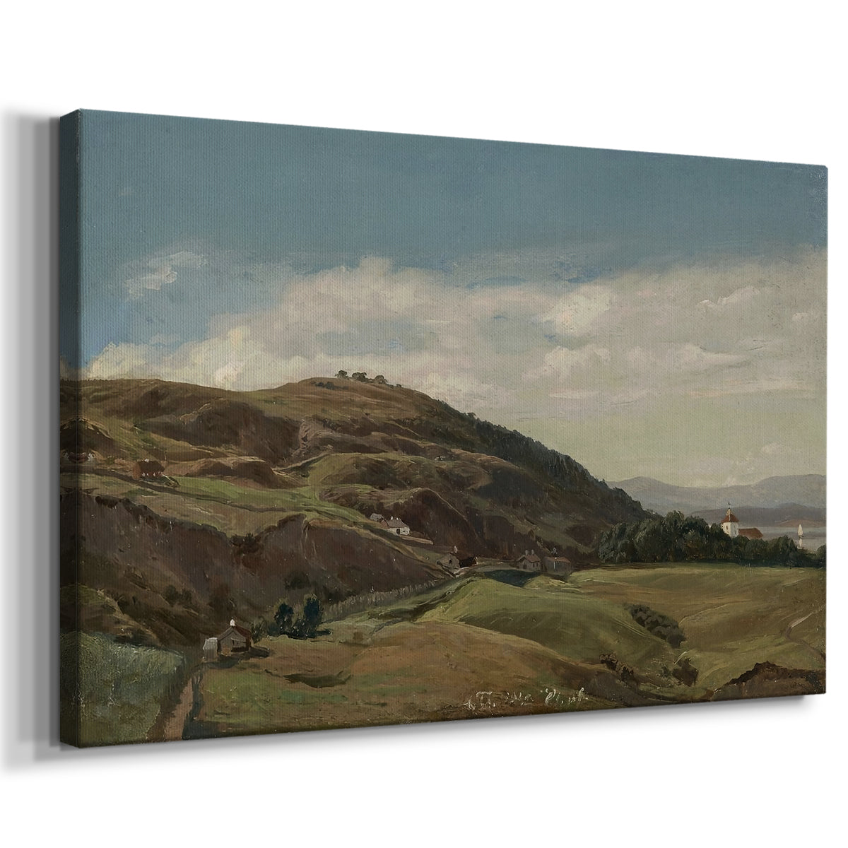 Canvas art print featuring a Norwegian countryside with distant church overlooking fjord and fields, displayed at an angle