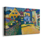 Canvas art print featuring a bright landscape showing buildings along a path with strong color contrast, displayed at an angle