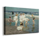 Canvas art print featuring a beach scene with figures bathing and standing in waves under bright sky, displayed at an angle