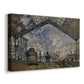 Canvas art print featuring an impressionist scene of trains and smoke inside busy railway station, displayed at an angle