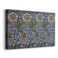 Canvas art print featuring a textile design featuring animals among foliage in repeating arrangement, displayed at an angle