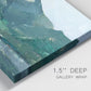Close-up view of wrapped canvas corner featuring muted mountain range in grey tones.