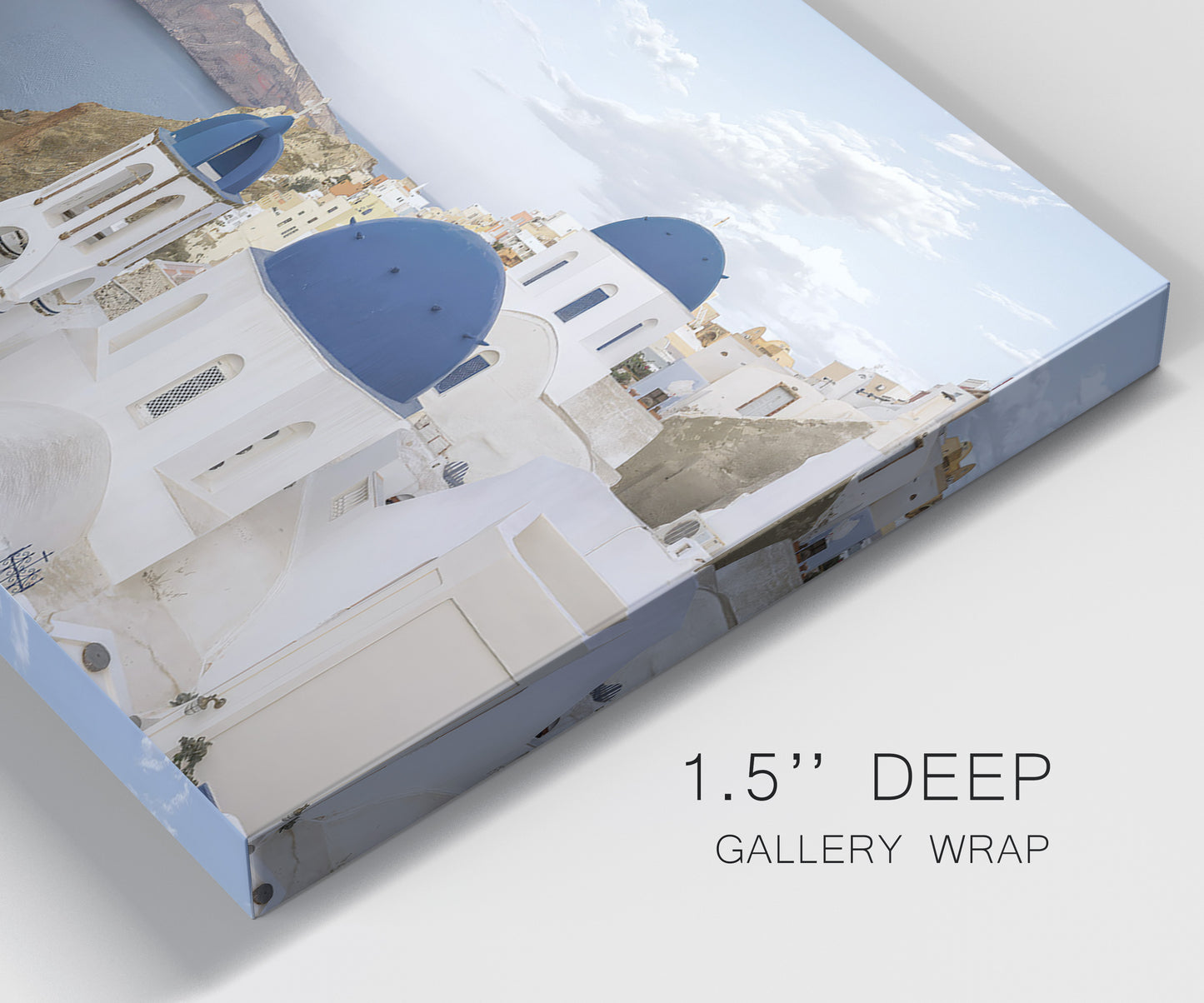 Close-up view of wrapped canvas corner featuring white buildings overlooking sea cliffs.