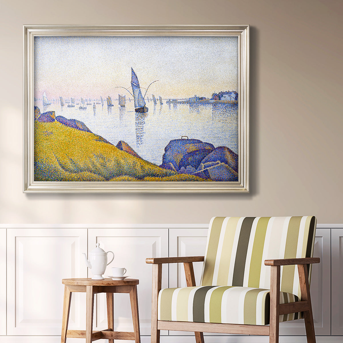 Impressionist coastal harbor at dusk by Paul Signac in an ornate champagne frame displayed in a light-toned interior setting.