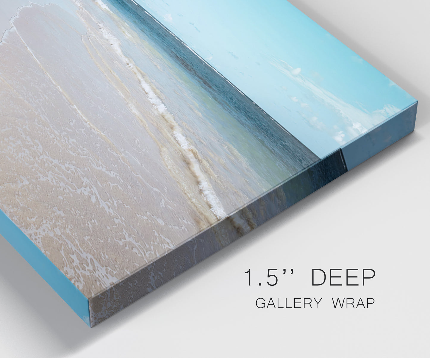Close-up view of wrapped canvas corner featuring white sand beach with gentle waves.