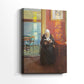 Side view of a canvas art print of a cozy room with rich red walls and a seated figure absorbed in a book, showing gallery-wrapped depth.