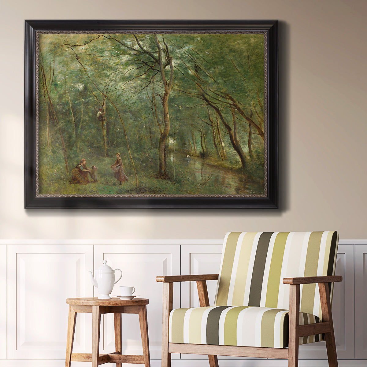 Traditional rural landscape scene with figures by Jean-Baptiste-Camille Corot in an ornate black frame with gilded inner detail displayed in a light-toned interior setting.