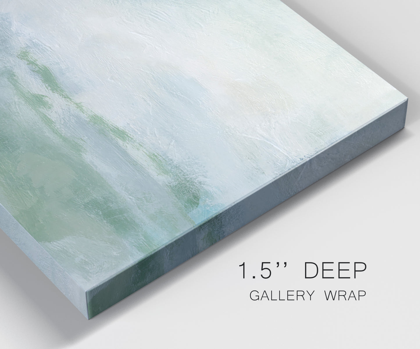 Close-up view of wrapped canvas corner featuring soft abstract coastal tones.