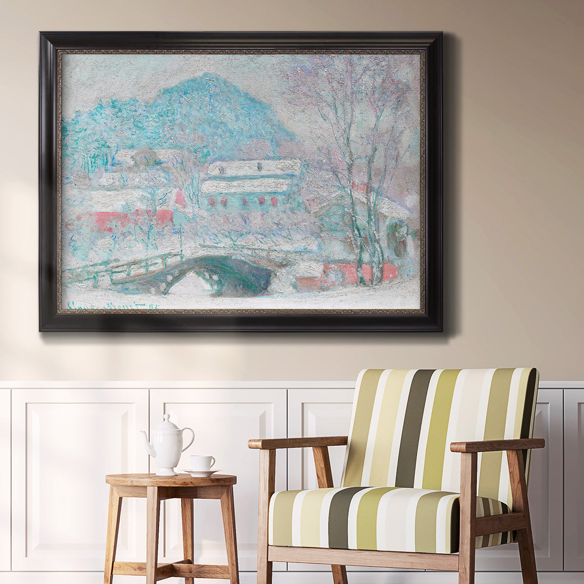 Impressionist coastal village landscape in Norway by Claude Monet in an ornate black frame with gilded inner detail displayed in a light-toned interior setting.