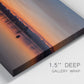 Close-up view of wrapped canvas corner featuring glowing sunset over water.