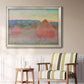 Impressionist haystack series landscape by Claude Monet in an ornate champagne frame displayed in a light-toned interior setting.