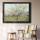 Impressionist white-blossomed orchard landscape by Vincent van Gogh in an ornate black frame with gilded inner detail displayed in a light-toned interior setting.