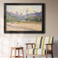 Impressionist valley landscape in southern France by Claude Monet in an ornate black frame with gilded inner detail displayed in a light-toned interior setting.