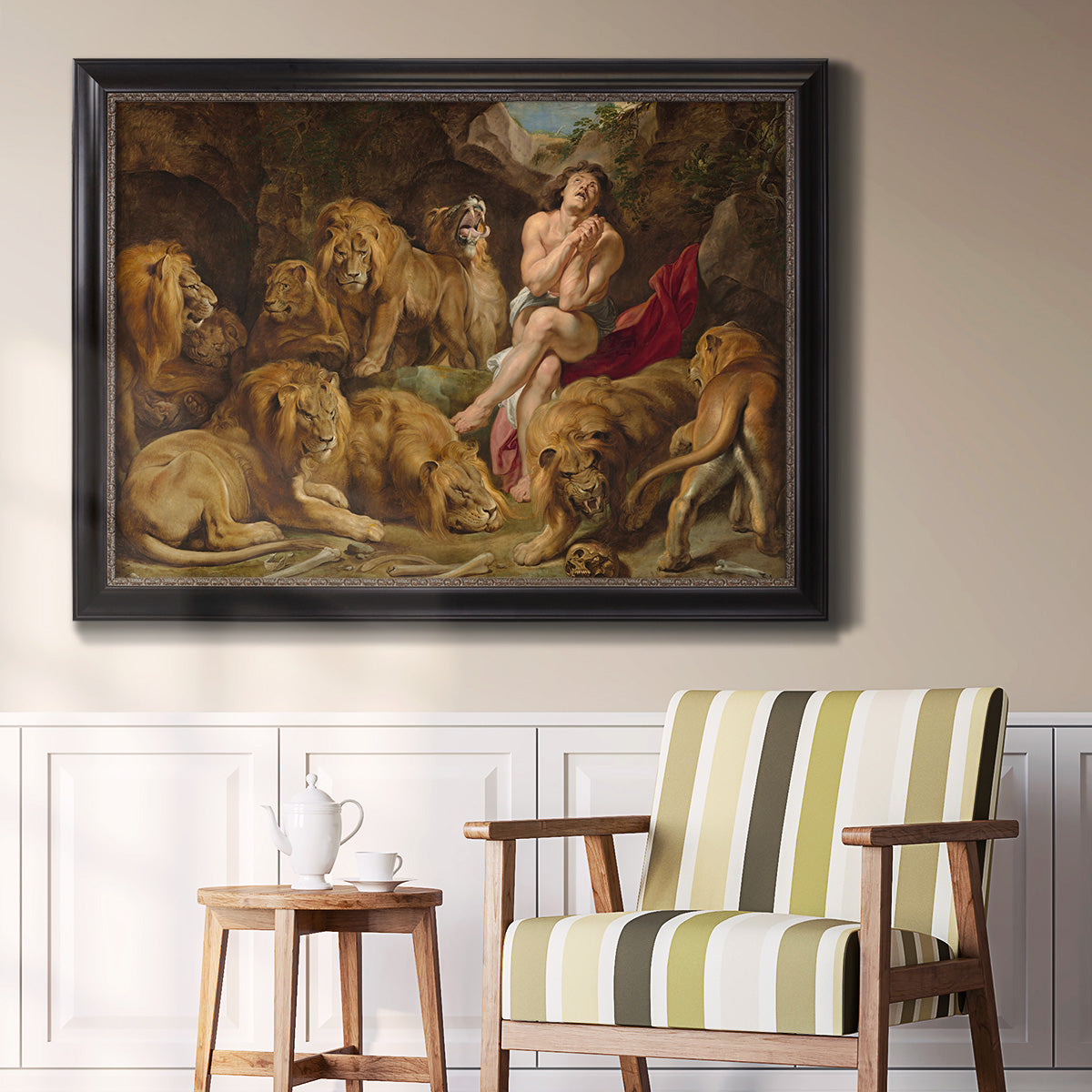 Dramatic biblical painting of Daniel with lions by Peter Paul Rubens in an ornate black frame with gilded inner detail displayed in a light-toned interior setting.