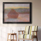 Impressionist haystack sunset scene in winter by Claude Monet in an ornate black frame with gilded inner detail displayed in a light-toned interior setting.
