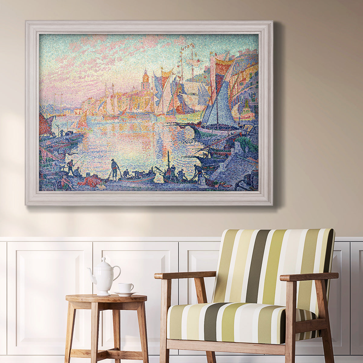 Impressionist Mediterranean harbor painting by Paul Signac in an ornate weathered white frame displayed in a light-toned interior setting.