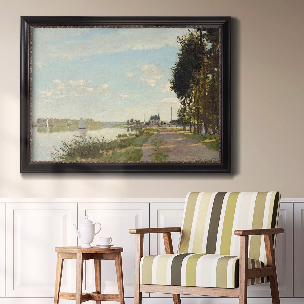 Impressionist river scene with red boats by Claude Monet in an ornate black frame with gilded inner detail displayed in a light-toned interior setting.